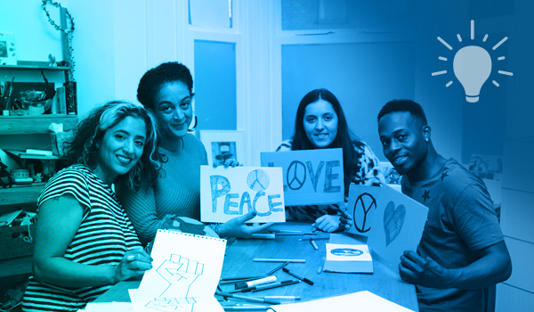 Diverse group of people holding signs around a table